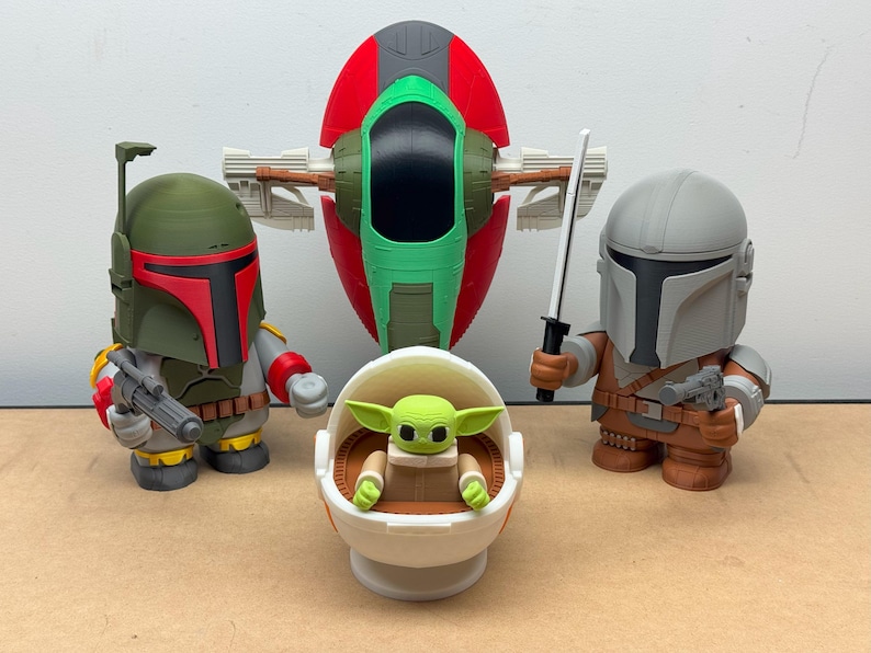 May include: A set of five Star Wars themed figurines, including Boba Fett, The Mandalorian, a green Baby Yoda in a pod, and a green and red spaceship.