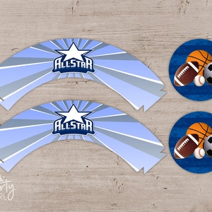 May include: Light blue and white All-Star cupcake wrappers and matching circular toppers with sports balls. The wrappers have a star and the word "ALLSTAR". The toppers feature a basketball, football, baseball, and soccer ball.