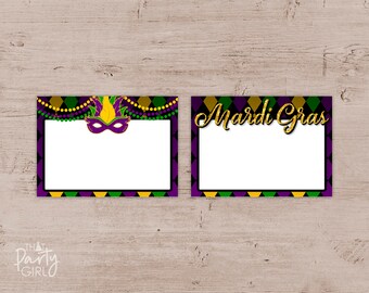 May include: Two printable Mardi Gras photo booth frames with a purple, green, and gold color scheme. The frame on the left features a purple mask with gold accents and green and gold beads. The frame on the right has the text "Mardi Gras" in gold glitter letters.