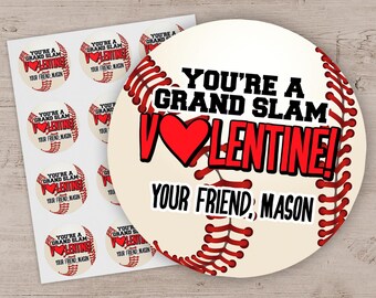 May include: A baseball-themed Valentine's Day sticker with the text "YOU'RE A GRAND SLAM VALENTINE!" in black and red. A red heart replaces the "O" in "VALENTINE". The sticker also includes the text "YOUR FRIEND, MASON". Several smaller stickers are also visible.