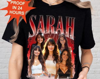 May include: Black t-shirt featuring the name "SARAH" in a red and silver gradient font. The shirt has a graphic of six women. The words "PROOF IN 24 HOURS" are in a starburst shape in the upper left corner.