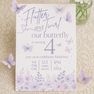 May include: A white invitation card with purple text and butterfly illustrations. The card reads "Flutter and Twirl" and announces a fourth birthday celebration. Decorative butterflies are scattered around the card.