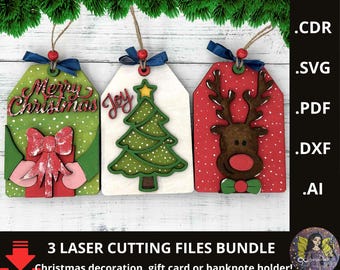 May include: Three laser-cut Christmas decorations. One green tag has a red bow and the words "Merry Christmas". Another white tag has a green Christmas tree and the word "Joy". The third red tag features a reindeer. Each tag has a blue ribbon.