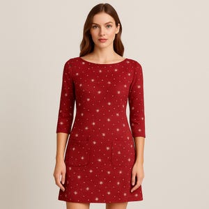 May include: A red dress with a boat neckline and three-quarter sleeves. The dress features a pattern of small, white snowflakes and two front pockets. The dress is knee-length.