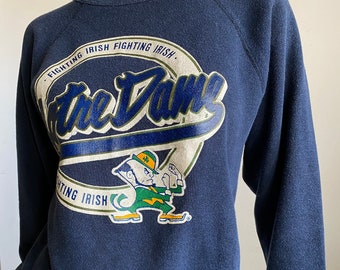 Vintage 80’s Notre Dame Fighting Irish Navy Long Sleeve Raglan Sweatshirt Soft Worn Comfy Fan Favorite Champion Label Size Small/Medium