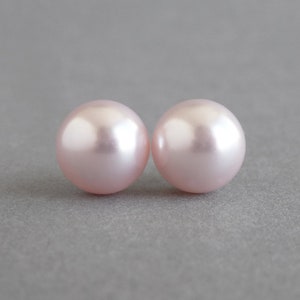 May include: Two round, pale pink pearl earrings.