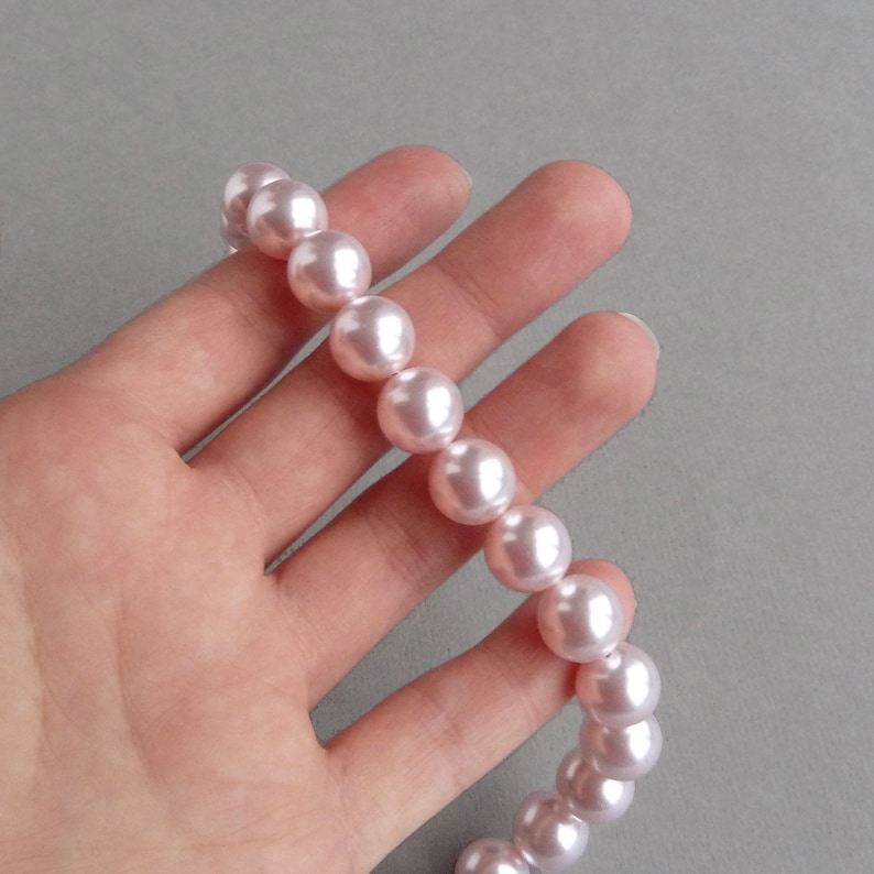 May include: A strand of pale pink faux pearl beads.