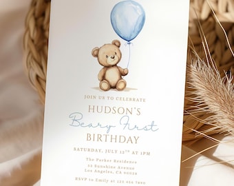 May include: A birthday invitation featuring a watercolor illustration of a teddy bear holding a blue balloon. The invitation text reads "Hudson's Beary First Birthday" with event details. The design is on a white background.