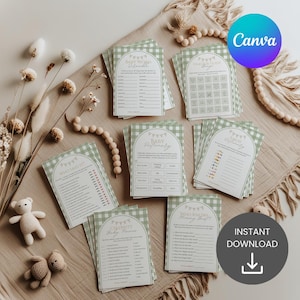 May include: A collection of baby shower game cards with a green gingham pattern and various game titles. The cards are arranged on a neutral-toned fabric with decorative elements like wooden beads and dried flowers. The Canva logo is visible.
