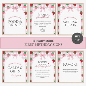 May include: A set of twelve 8x10 inch first birthday signs featuring a pink and white gingham background with red strawberry illustrations and a pink bow at the top of an arched frame. The signs include text for food, drinks, photo guestbook, sweets, treats, cards, gifts, books, and favors for a birthday celebration.