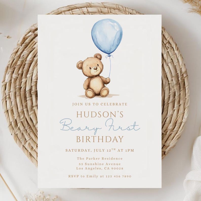May include: A light beige birthday invitation featuring a watercolor illustration of a teddy bear holding a blue balloon. The invitation text reads "Join us to celebrate Hudson's Beary First Birthday" with event details.