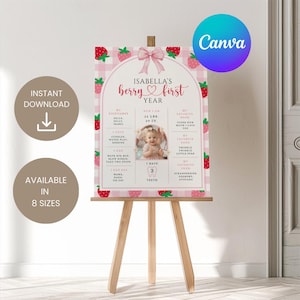 May include: A pink and white strawberry-themed first birthday sign on a wooden easel. The sign features the text "Isabella's berry first year" and includes a photo, measurements, and favorite things. The sign is available in 8 sizes.