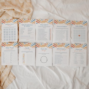 Puede incluir: Un conjunto de tarjetas de juegos para baby shower con un dise&ntilde;o de sol y arco&iacute;ris. Las tarjetas incluyen juegos como "Encuentra al invitado", "Baby Bingo" y "Dibuja al beb&eacute;". La paleta de colores incluye naranja, azul y amarillo.
