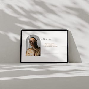 May include: A black tablet displays a website design with the text "Yimu Studio." The design features a portrait of a person and the quote, "We Find Solutions To Problems Creatives Did Not Know They Had."