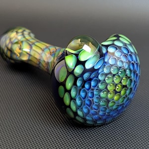 May include: A set of three ceramic mugs with a speckled, cream-colored glaze. Each mug features a different hand-painted floral design in shades of blue, green, and yellow. The mugs have a simple, rounded shape and a comfortable handle.