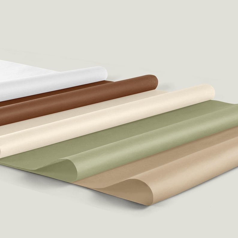 May include: An assortment of rolled paper in various colors, including white, brown, beige, and green. The paper is arranged in layers, with the edges of the sheets visible. The image has a neutral background.