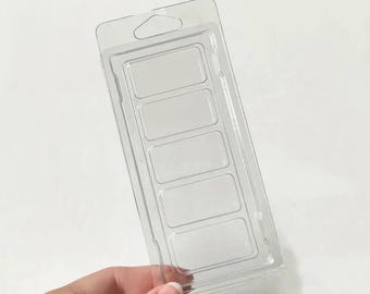 May include: A clear plastic clamshell container featuring five rectangular compartments arranged in a vertical column. The packaging includes a top section with a die-cut hole for hanging, designed for holding wax melts or small craft items.