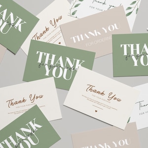 May include: Several thank you cards in shades of green and beige. The cards display the phrases "Thank You" and "Thank You for Your Order" in stylish typography. Some cards include a small heart symbol.