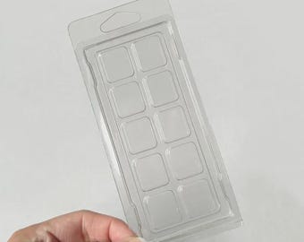 May include: A clear, rectangular plastic clamshell mold featuring ten individual rectangular cavities arranged in two columns of five. The top of the packaging includes a die-cut hole for hanging, designed for holding wax melts or small items.