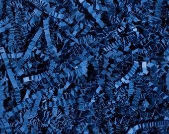 May include: Close-up of shredded blue paper, creating a textured, abstract background. The paper is cut into thin, wavy strips, and the color is a deep, saturated blue. This material is often used for gift packaging and decorative purposes.