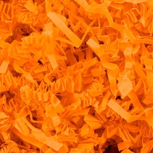 May include: A close-up shot of bright orange crinkle paper, a decorative packaging material. The paper is cut into thin strips with a textured, ruffled appearance. The image is filled with the paper, creating a dense, vibrant background.