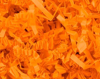 May include: Close-up of bright orange crinkle paper, a decorative packaging material. The paper is cut into thin strips and has a textured, ruffled appearance. The image is filled with the paper, creating a dense, vibrant background.