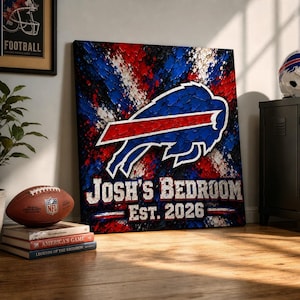 Op de afbeelding: Een vierkant canvas kunstwerk met het Buffalo Bills-logo in blauw en rood met een textuurverfeffect. De tekst luidt JOSH'S BEDROOM EST. 2026 in witte blokletters tegen een levendige abstracte achtergrond in rood, wit en blauw.