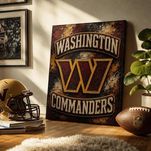May include: A rectangular canvas wall art piece featuring the Washington Commanders logo and text in burgundy and gold. The design has a textured, distressed appearance with the team name arched above and below a large stylized letter W.
