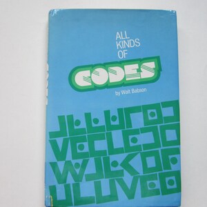 May include: A vintage book titled "All Kinds of Codes" by Walt Babson. The cover is light blue with green and white text. The word "CODES" is in a large, stylized font. Additional green text is at the bottom.