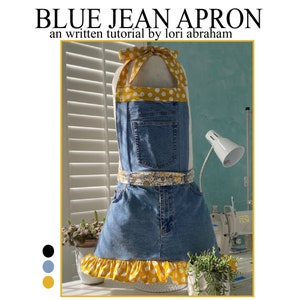 May include: A blue jean apron with a yellow polka dot ruffle trim and a yellow floral print belt. The apron has a large pocket on the front and is styled on a mannequin.