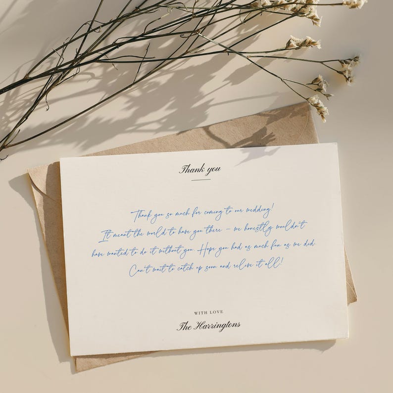 May include: A cream-colored thank you card with blue handwritten text, resting on a brown envelope. The card reads "Thank you" at the top, followed by a message and "With Love, The Harringtons."