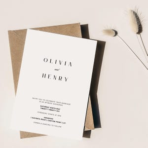 May include: A minimalist wedding invitation featuring the names "OLIVIA and HENRY" in elegant black font. The invitation includes details for the ceremony, date, time, and location, printed on a white card. The card is layered on a brown envelope and a black envelope.