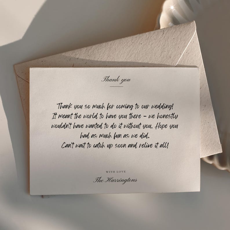 May include: A cream-colored thank you card with the words "Thank you" at the top. The card includes a handwritten message expressing gratitude for attending a wedding, along with an envelope.
