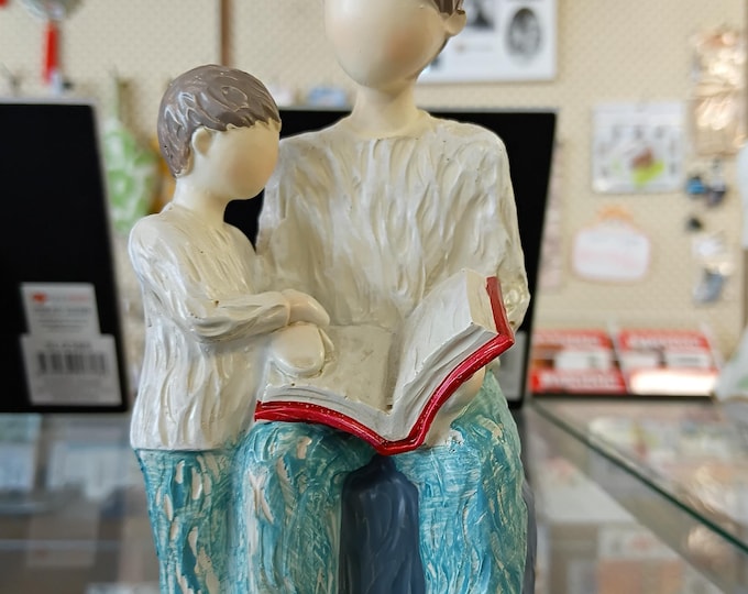 Decorative Figurine of a Parent and Child Sitting Together While Reading a book.