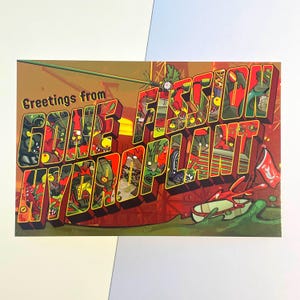 May include: A postcard with the text "Greetings from GONE FISSION HYDROPLANT" in a 3D, cartoonish style. The letters are filled with various green and yellow cartoon characters and imagery, set against a red and brown background.