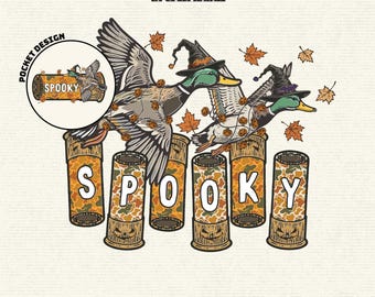 May include: A digital graphic featuring two mallard ducks wearing black witch hats, flying over six shotgun shells arranged in a row. The shells have a camouflage pattern and the word SPOOKY is spelled out across them. Orange maple leaves surround the ducks.