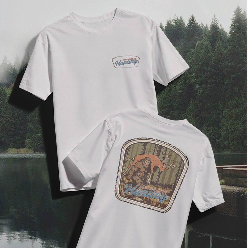 May include: Two white t-shirts. One shirt has a small patch with the word "Hunting" in a blue and tan design. The other shirt has a large graphic on the back featuring a Bigfoot and a deer in a forest setting, with the word "Hunting" below.