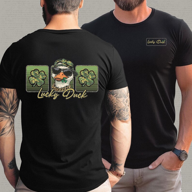 May include: Black t-shirts with a "Lucky Duck" graphic. The graphic features a duck wearing sunglasses, a camouflage hat, and a gold chain, with a shamrock in its beak. The back of the shirt has the graphic with three shamrocks. The front of the shirt has the text "Lucky Duck".