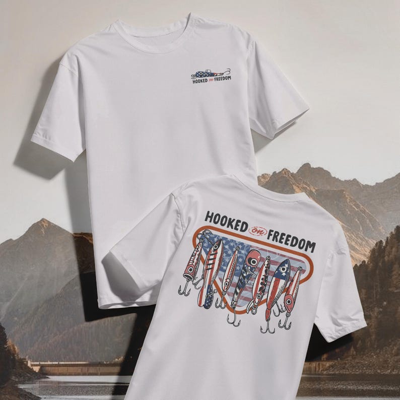 May include: Two white t-shirts. One has a small graphic and the text "HOOKED ON FREEDOM" on the front. The other has a graphic of fishing lures with an American flag design and the text "HOOKED ON FREEDOM" on the back.