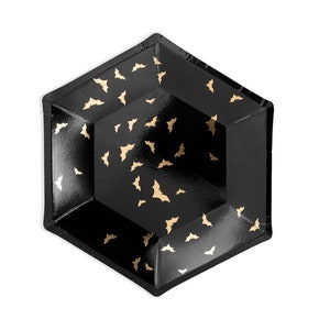 May include: Black hexagonal paper plate with gold bat silhouettes. The plate has a raised edge and is designed for Halloween or themed parties. The bats are scattered across the plate's surface.