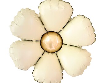 May include: A large, cream-colored, foil balloon shaped like a flower with six petals and a gold center.