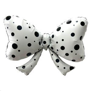 May include: A large, white bow-shaped balloon with black polka dots. The balloon is inflated and has a shiny surface. The bow has two loops and two streamers, perfect for a party or celebration.