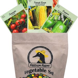 Op de afbeelding: Een bruine papieren zak met het label Freedom Farms Vegetable Set en een zwart eendenlogo, met vijf zakjes zaden: tuinboon, wortel, suikerma&iuml;s, tomaat en paprika. Elk zakje toont een kleurenfoto van de specifieke groentesoort.