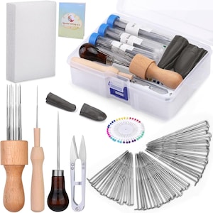 May include: A needle felting kit with various tools, including needles, a wooden handle, scissors, and a foam block. The kit also includes a clear plastic container with needles and a small booklet.