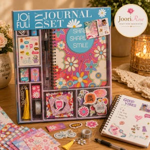 May include: A Joifuli DIY journal set in a blue box containing a spiral-bound notebook with a floral pattern and the text Shine Share Smile, a black pen, stickers, a yellow tassel keychain, decorative paper, and a roll of glitter tape.
