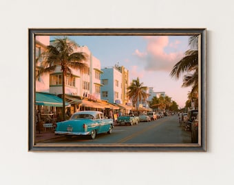 May include: Framed print of a vintage street scene with pastel-colored buildings, palm trees, and classic cars. The image captures a retro aesthetic, evoking a sense of nostalgia and a tropical atmosphere. The artwork is framed in a dark, rustic-style frame.