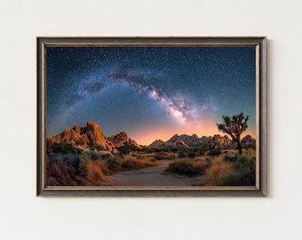 May include: Framed landscape art print featuring a desert scene under a starry night sky. The image shows a path leading towards the horizon, with a Joshua tree on the right. The sky displays the Milky Way galaxy in shades of blue and purple.