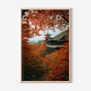 May include: A framed print featuring a Japanese temple surrounded by vibrant autumn foliage. The temple has a multi-tiered pagoda and traditional architecture. The leaves are a mix of red, orange, and green, creating a colorful landscape.