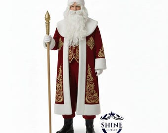 May include: A Santa Claus costume. The long, red coat has gold embroidery and white trim. The costume includes a matching hat, white beard, gloves, and black boots. Santa is holding a gold-topped staff. The costume is from Shine Outlet.
