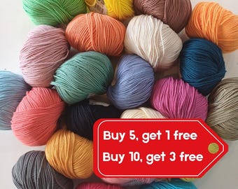 May include: A collection of colorful yarn skeins in various shades, including green, yellow, orange, pink, and blue. The image also includes a red tag with the text "Buy 5, get 1 free" and "Buy 10, get 3 free".
